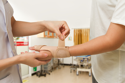 Nurse putting on a wrist Brace